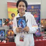 Reader enjoying a novel by African American fantasy and romance author N.D. Jones.
