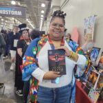 Reader enjoying a novel by African American fantasy and romance author N.D. Jones.
