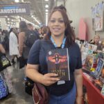 Reader enjoying a novel by African American fantasy and romance author N.D. Jones.