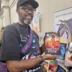 Reader enjoying a novel by African American fantasy and romance author N.D. Jones.