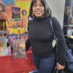Reader enjoying a novel by African American fantasy and romance author N.D. Jones.