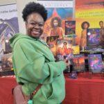 Reader enjoying a novel by African American fantasy and romance author N.D. Jones.