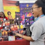 Reader enjoying a novel by African American fantasy and romance author N.D. Jones.