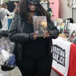 Reader enjoying a novel by African American fantasy and romance author N.D. Jones.