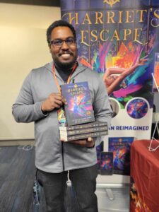 Black male Reader with books by ND Jones