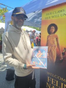 Black Man holding Major Arcana coloring book by ND Jones